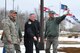 Col. Benjamin L. Spencer, 319th Air Base Wing commander (right), points to an area near the main gate to verify a location to be improved by scheduled construction March 28, 2018, at Grand Forks Air Force Base, N.D. The commander, along with the 319 ABW command chief, Chief Master Sgt. Brian Thomas (left), Terry Rutan, 319th Security Forces Squadron operations officer, and other subject matter experts surveyed security elements designed to prevent unauthorized entry to the installation. Construction on both installation gates is scheduled to start in April 2018 and includes many security upgrades. (U.S. Air Force photo by Master Sgt. Amanda Callahan)