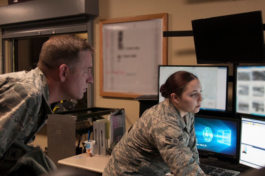 Col. Benjamin Spencer, 319th Air Base Wing commander (right), briefs member of the 319th Security Forces Squadron during guard mount March 28, 2018, on Grand Forks Air Force Base, N.D. He and Chief Master Sgt. Brian Thomas, 319 ABW command chief, used the opportunity to applaud defenders for their dedication and professionalism, and recognized the challenges they face while protecting Airmen and their families. (U.S. Air Force photo by Master Sgt. Amanda Callahan)