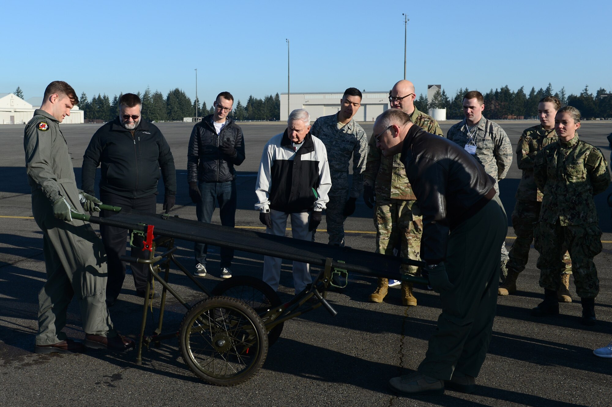 Members of the Association of Military Osteopathic Physicians and Surgeons (AMOPS) practice using a NATO litter carrier, March 10, 2018, at Joint Base Lewis-McChord, Wash. AMOPS members included military doctors, medical students on military scholarships and retirees. (U.S. Air Force photo by Airman 1st Class Sara Hoerichs)