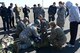 Washington National Guard crew chiefs assist Association of Military Osteopathic Physicians and Surgeons members to secure a simulated patient in a sked, March 10, 2018, at Joint Base Lewis-McChord, Wash. A sked is a tough plastic stretcher that can be used to move patients both on the ground and up to a hovering helicopter.  (U.S. Air Force photo by Airman 1st Class Sara Hoerichs)