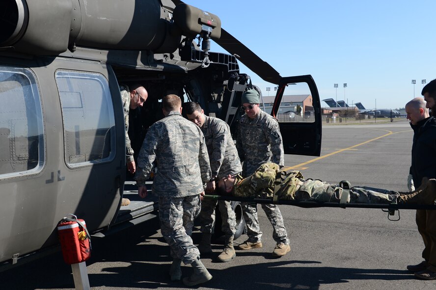 Members of the Association of Military Osteopathic Physicians and Surgeons (AMOPS) load a simulated patient onto a UH-60 Black Hawk helicopter, March 10, 2018, at Joint Base Lewis-McChord, Wash. The AMOPS members were practicing transporting patients to and from military aircraft. (U.S. Air Force photo by Airman 1st Class Sara Hoerichs)