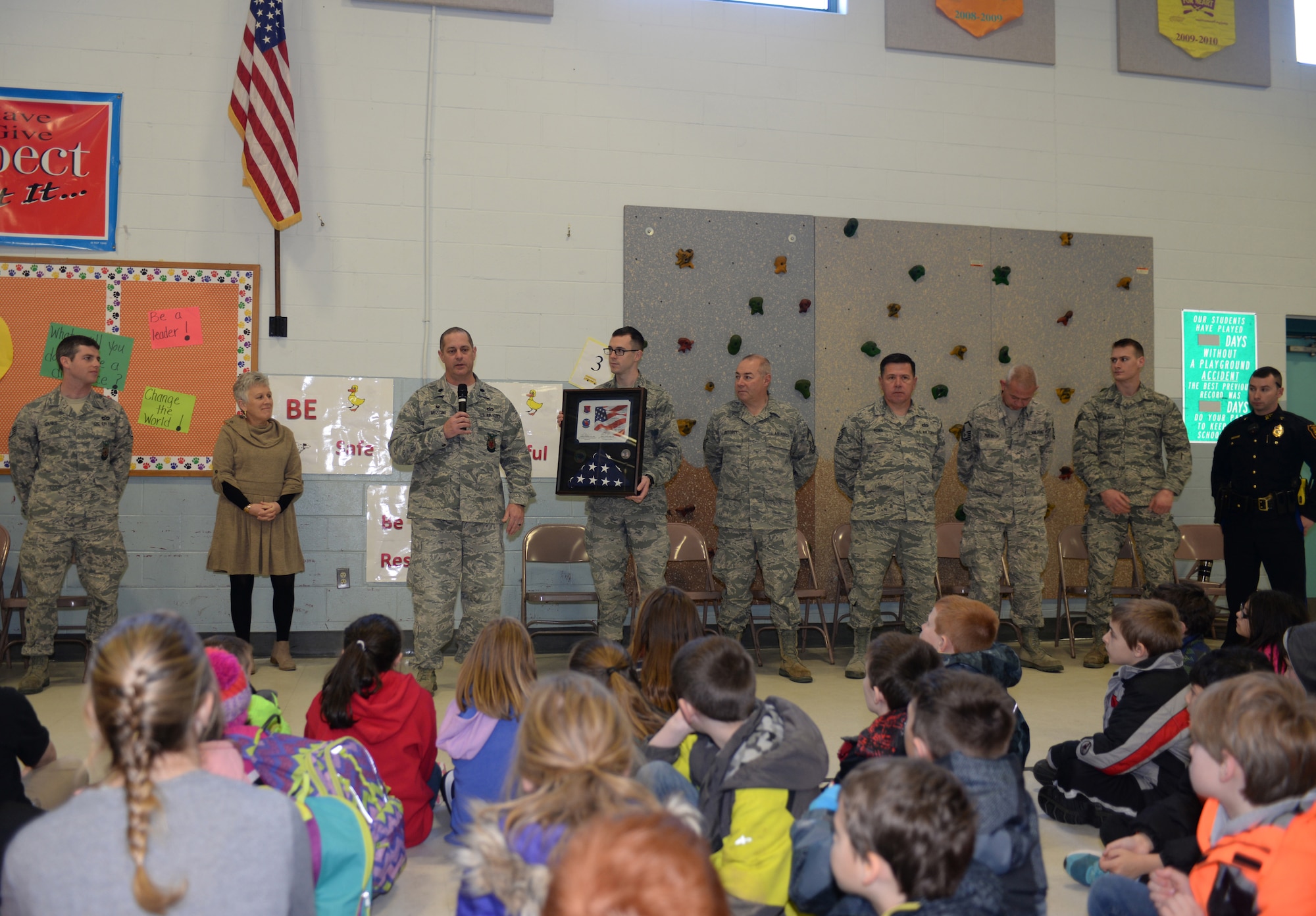 Lt. Col. Eugene R. Mozzoni, 157th Civil Engineering Squadron commander, thanks students of the McClelland Elementary School during a brief ceremony thanking the students for sending letters to the 157th Civil Engineering Squadron while they were deployed to the middle east over the past holiday season. March 27, 2018, Rochester, N.H.  The flag was flown over the country of Kuwait during Christmas while the squadron was deployed there. (N. H. Air National Guard photo by Master Sgt. Thomas Johnson)