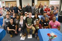 Tinker Air Force Base leadership, Airmen participants and Pam Kloiber, executive director for the Team Tinker Home Away From Home program, far left, joined together for a group photo with the five panelists, all military veterans, during  the Home Away From Home "Meet the Heroes Night" held March 22 at the American Red Cross office in downtown Oklahoma City.