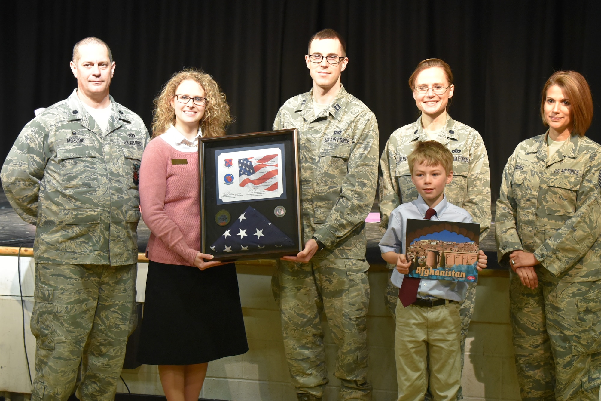 Lt. Col. Eugene R. Mozzoni, 157th Civil Engineer Squadron commander, thanks students during a ceremony at the Portsmouth Christian Academy Elementary School in Dover, N.H. March 30, 2018. Mozzoni presented a flag and certificate to the students during a ceremony thanking the students for sending letters to the engineers while they were deployed to the Middle East. The flag was flown over the country of Kuwait during the last holiday season. (N.H. Air National Guard photo by Mrs. Donna Hall)
