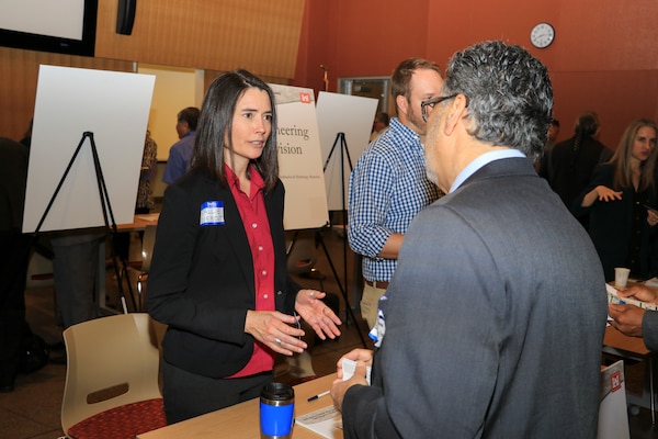 Supervisory Biologist Sallie Diebolt, Arizona-Nevada Area Office, U.S. Army Corps of Engineers Los Angeles District, explains the Corps Regulatory Program to a prospective contractor at the Business Opportunities Open House March 22 at GateWay Community College in Phoenix, Arizona. More than 150 business representatives attended the event to learn of the Corps' business lines and upcoming contracting opportunities.