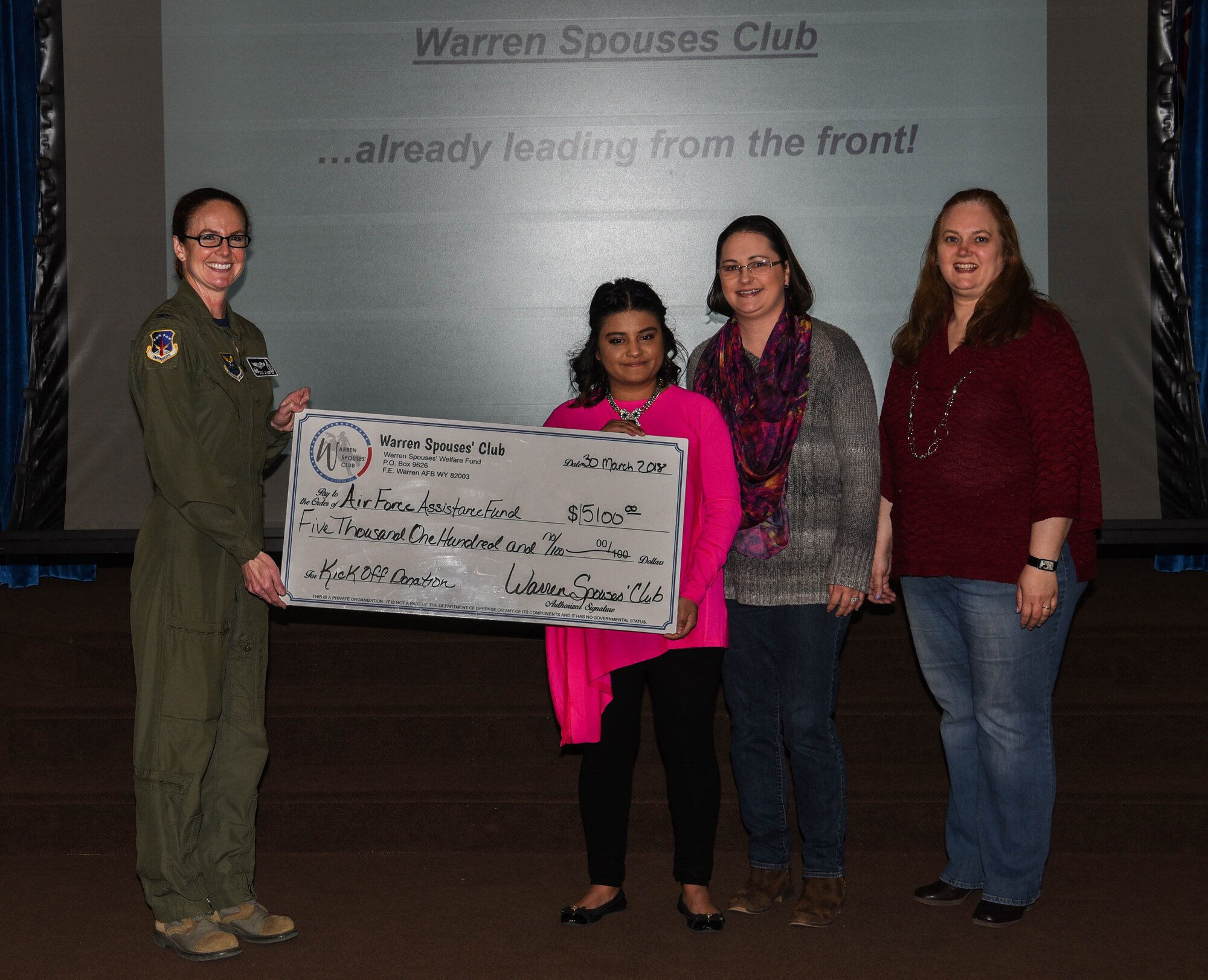 The Warren Spouse Club presented Col. Stacy Jo Huser, 90th Missile Wing commander, with a check for $5,100 for the Air Force Assistance Fund at F.E. Warren Air Force Base, Wyo., March 30, 2018. The WSC raised the money during a recent auction event, Boots and Baubles. AFAF helps Airmen with financial aid in instances such as, emergency situations, securing a retirement home for widows or widowers of Air Force members and more. (U.S. Air Force photo by Airman 1st Class Braydon Williams)