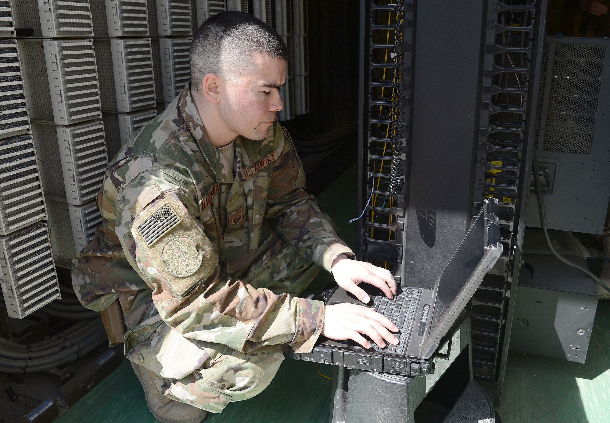 Staff Sgt. Brandon Hasegawa, 455th Expeditionary Communication Squadron cyber transport technician, activates a network port Mar. 22, 2018 at Bagram Airfield, Afghanistan.