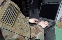 Staff Sgt. Brandon Hasegawa, 455th Expeditionary Communication Squadron cyber transport technician, activates a network port Mar. 22, 2018 at Bagram Airfield, Afghanistan.