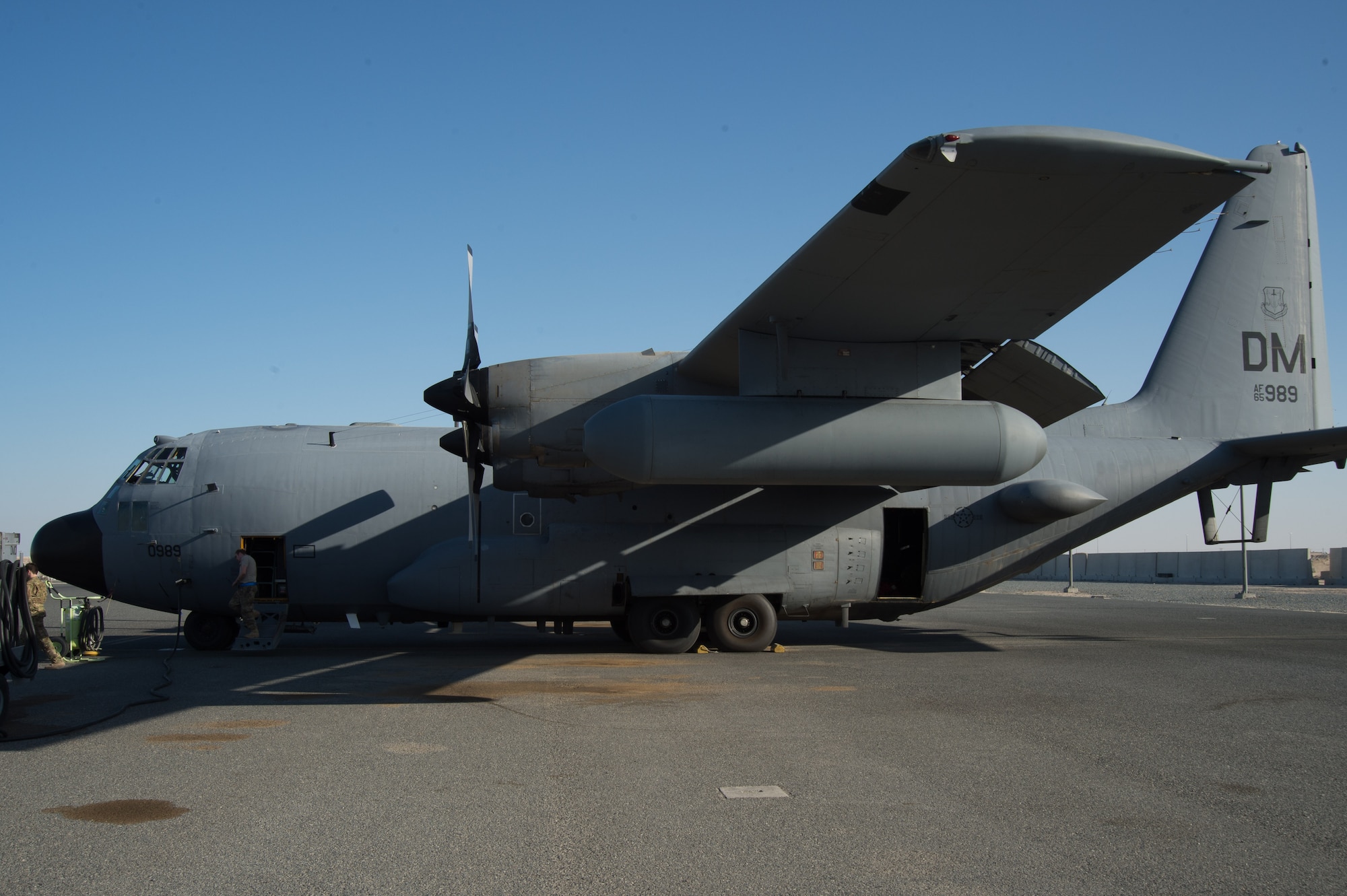EC-130H Compass Call aircraft tail number 65-0989, built in 1965, is parked on the flightline Feb. 4, 2018, at an undisclosed location in Southwest Asia.