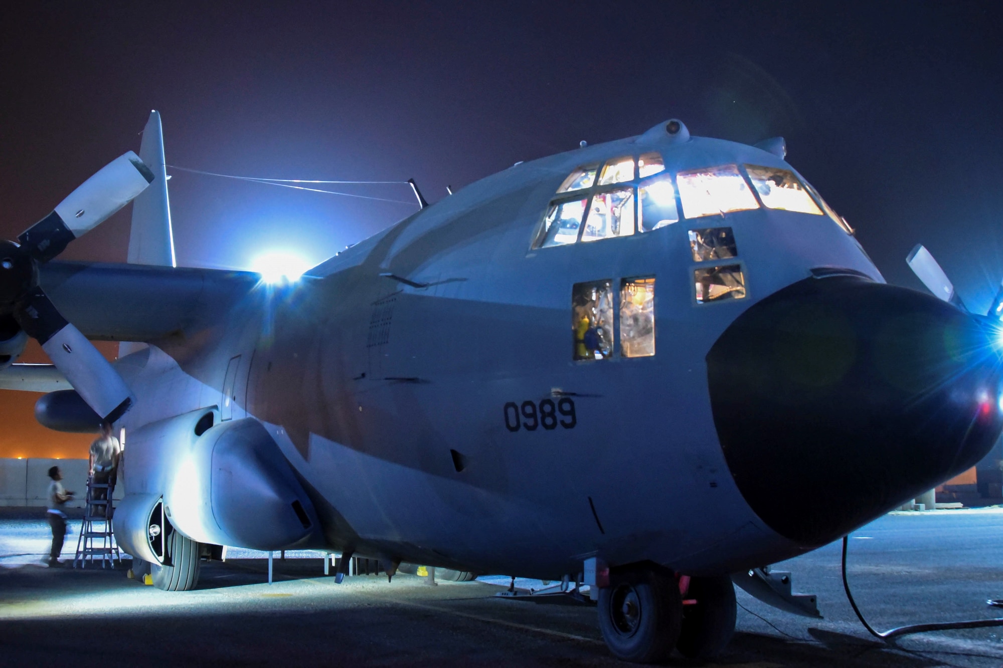 Airmen from the 43rd Expeditionary Electronic Combat Squadron perform maintenance on an EC-130H Compass Call at an undisclosed location in Southwest Asia, April 13, 2018.