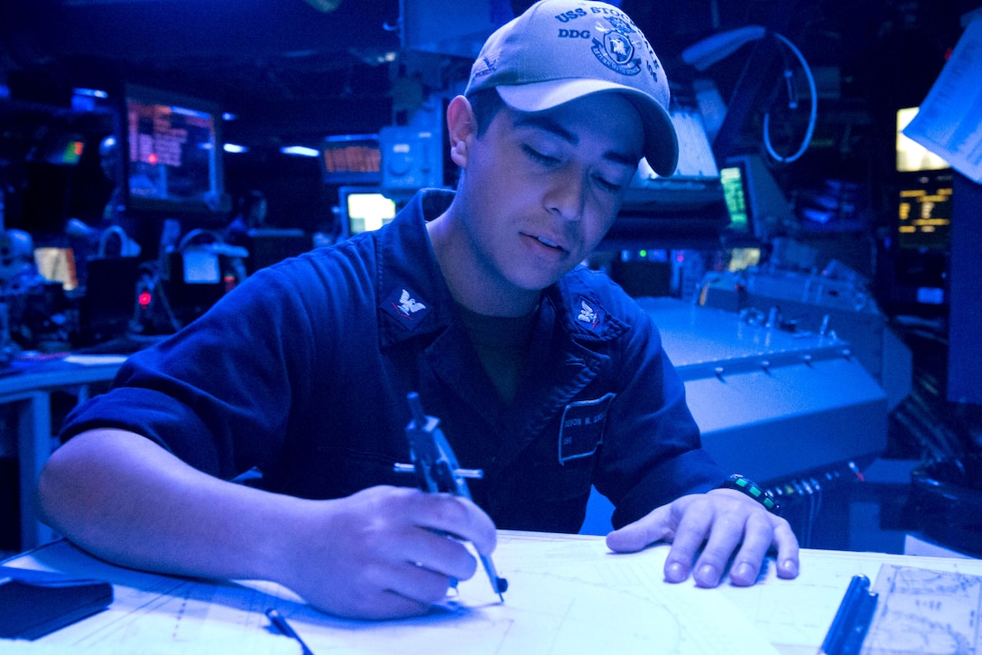 A sailor plots the closest point of approach on a maneuvering board.