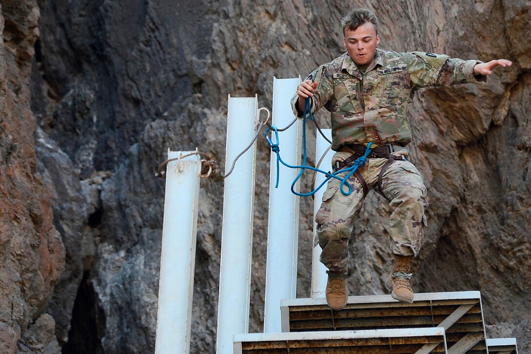 A soldier navigates a vertical obstacle course.