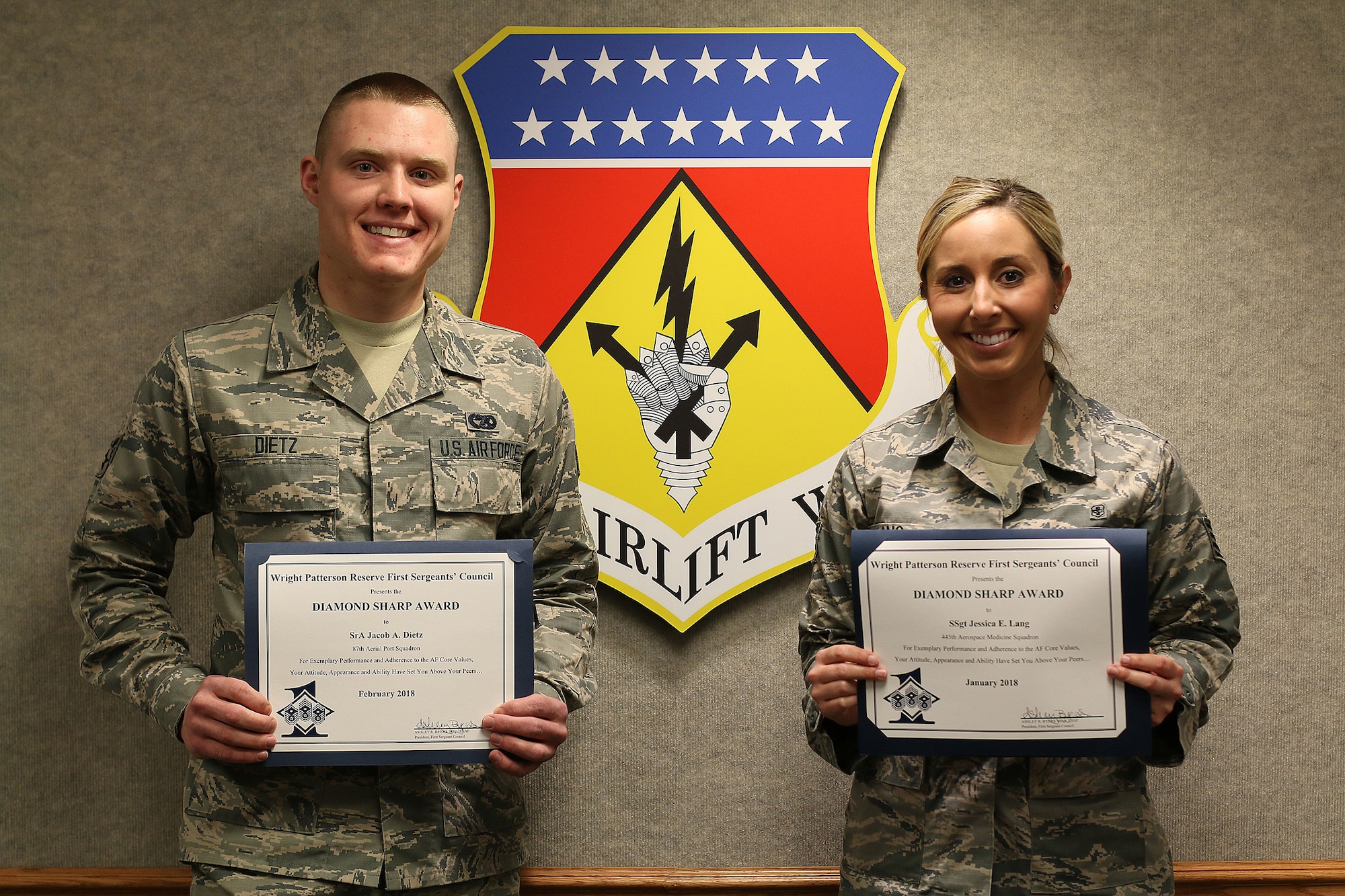 Senior Airman Jacob Dietz, 87th Aerial Port Squadron and Staff Sgt. Jessica Lang, 445th Aerospace Medical Squadron, display Diamond Sharp Awards they were presented April 7, 2018. Airman Dietz is the recipient of the February 2018 award and Sergeant Lang received the January 2018 award.