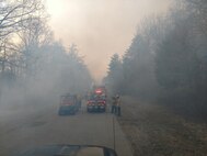 Fire and Emergency responders are shown as they control access to a wildfire at one of the many ranges throughout Marine Corps Base Quantico. This particular fire lasted two days of dedicated support from the fire department.