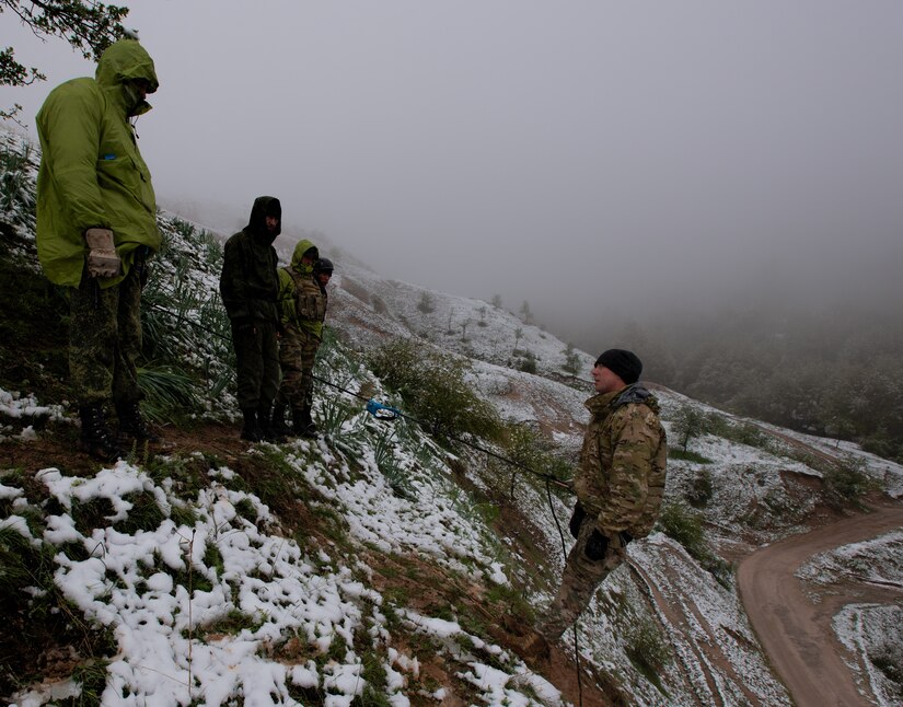 Tajikistan Peacekeeping Battalion of the Mobile Forces soldiers observe 1st Lt. Gregory “Matts” Wilcoxen, platoon leader, Bravo Company, 1st Battalion, 37th Armored Regiment, 2nd Brigade Combat Team, 1st Armored Division, as he explains the use of an ascending device at a mountain training camp outside of Dushanbe, Tajikistan, April 18, 2018. This mountain warfare information exchange was part of a larger military-to-military engagement taking place with the Tajikistan Peacekeeping Battalion of the Mobile Forces and the 648th Military Engagement Team, Georgia Army National Guard, involving border security tactics and techniques.