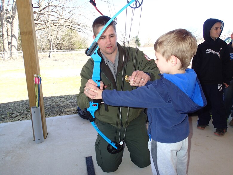 Devin Holt, Kansas City District park ranger at Pomme de Terre Lake, provides assistance during an archery clinic hosted at the Pomme de Terre Archery Range near Hermitage, Missouri.