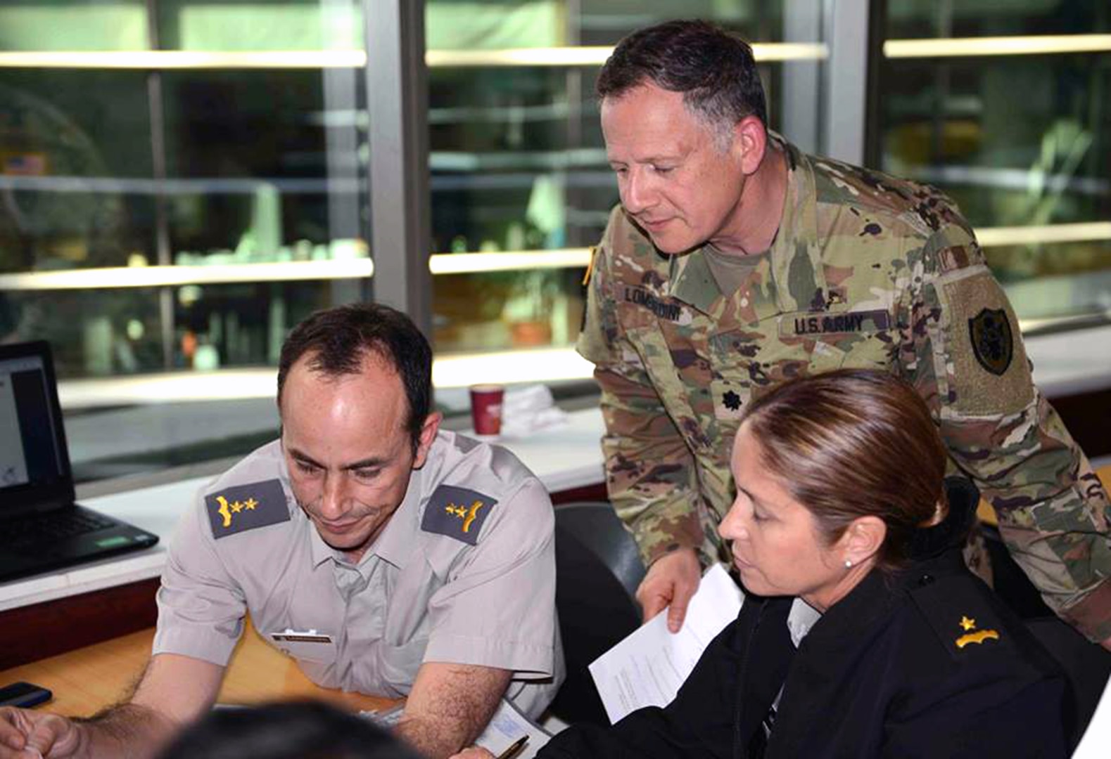 (From left) Chilean Army Lt. Col. Pablo Larraguibel, U.S. Army Lt. Col. Eric Lombardini and Chilean Army Maj. Claudia Lucar participate an exercise focusing on a vector-borne risk assessment pre-deployment scenario April 17.