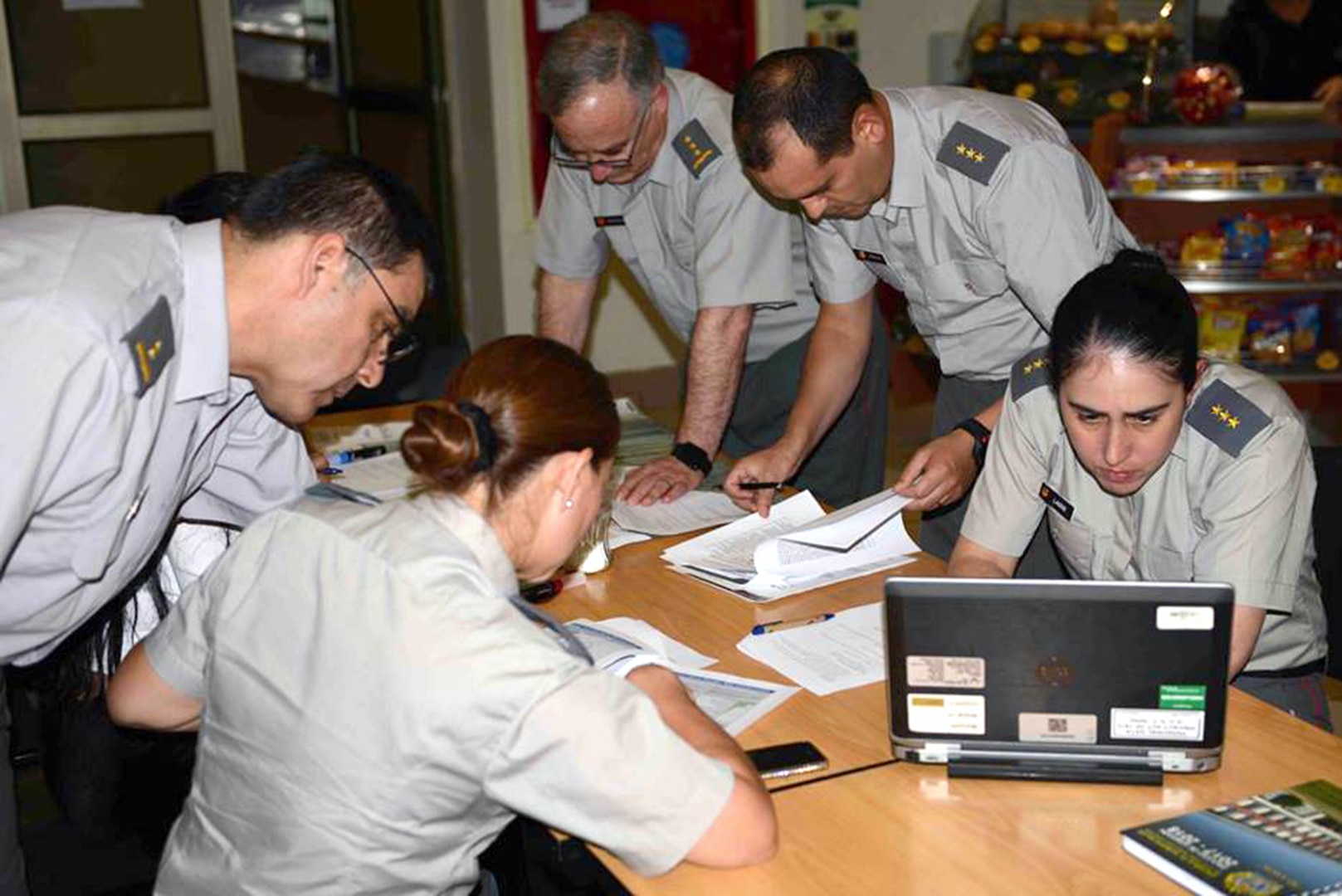 Chilean Army Capt. Javiera Lagos (right), a veterinary medicine specialist, reviews data during a group exercise focusing on a vector-borne risk assessment pre-deployment scenario April 17.