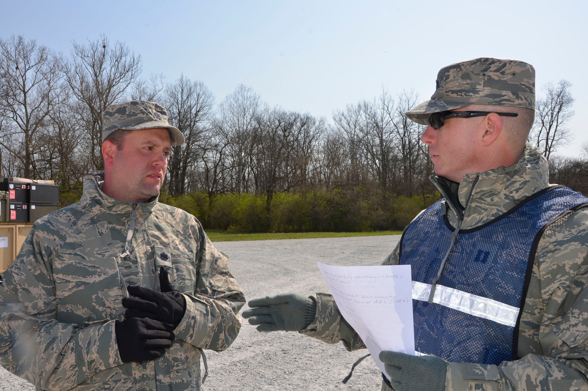 Capt. Lee Laughridge, (right) chief, Air Forces Northern  Medical Operations and Training, talks with Lt, Col. Randall Shiflett 81st Medical Group medical control center team chief, about the daily operations situational report Shiflett submitted during the Expeditionary Medical Support field confirmation exercise here April 18. The confirmation exercise is evaluating the tactics, techniques and procedures of EMEDS operations during a domestic U.S. contingency such as a natural disaster. (Air Force photo by Mary McHale)