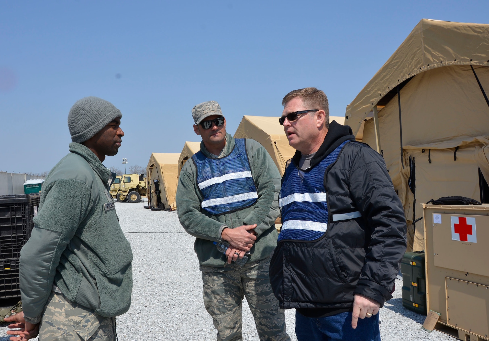 Jeff Brandenburg, chief, Air Forces Northern Medical Plans and Logistics, talks with Tech. Sgt. Quentin Richardson, 81st Medical Group Medical Support Squadron logistics, during the Expeditionary Medical Support field confirmation exercise here April 18. The confirmation exercise is evaluating the tactics, techniques and procedures of EMEDS operations during a domestic U.S. contingency such as a natural disaster. (Air Force photo by Mary McHale)
