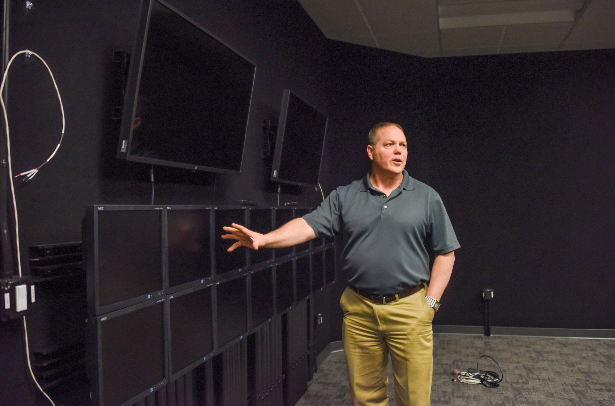 Nathan Hill, the Lockheed Martin F-35 Training Systems Manager for the simulators at Hill Air Force Base, Utah, showcases multiple display screens in a debrief room
