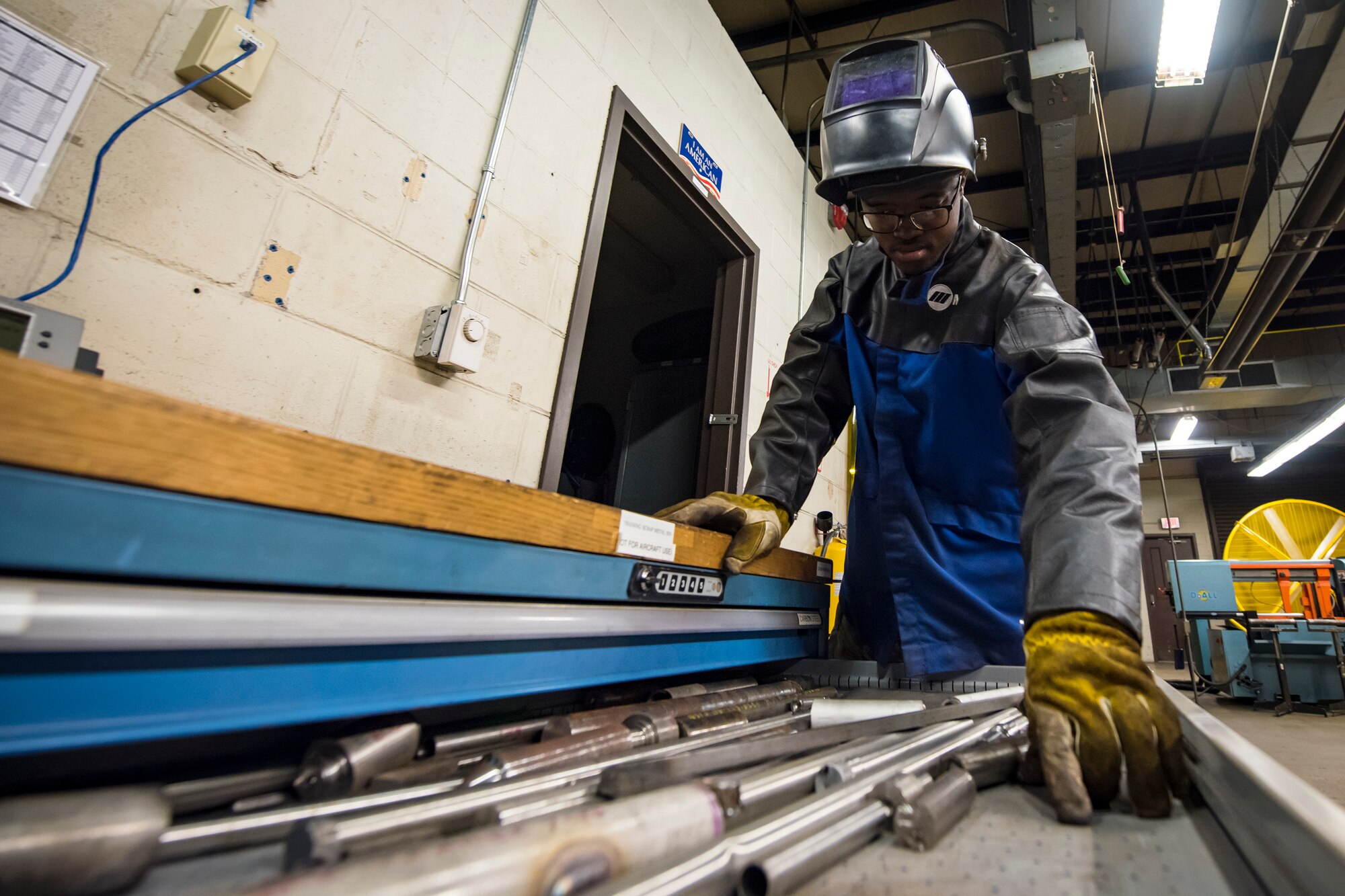 Airman 1st Class Isaiah Jackson, 23d Maintenance Squadron aircraft metals technology journeyman, grabs a piece of stainless steel, April 25, 2018, at Moody Air Force Base, Ga. Metals technicians support the mission by utilizing fabrication techniques to repair and overhaul countless tools and aircraft parts. The technicians strive to exercise safe and precise fabrication techniques to be able to sufficiently handle their intense workload. (U.S. Air Force photo by Airman 1st Class Eugene Oliver)