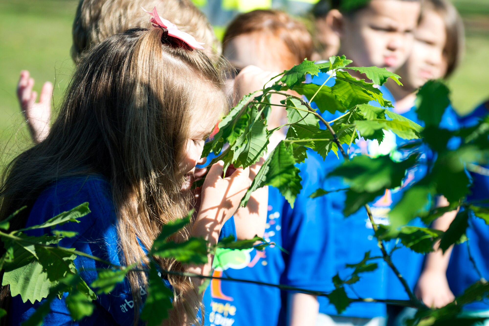A child from Moody’s child development center smells the leaf of an oak tree during Arbor Day, April 27, 2018, at Moody Air Force Base, Ga. Moody annually celebrates the holiday which encourages the benefits of planting trees. For 19 years the base has been a part of the Tree City USA Program by the National Arbor Day Foundation, to better prepare for the future of caring for their Airmen through improved ecological sustainability.  (U.S. Air Force photo by Airman 1st Class Erick Requadt)