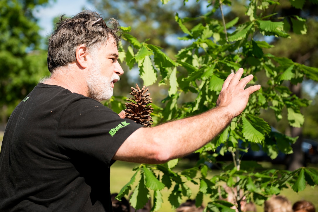 John Crain, 23d Civil Engineer Squadron forester, explains tree life cycles during Arbor Day, April 27, 2018, at Moody Air Force Base, Ga. Moody annually celebrates the holiday which encourages the benefits of planting trees. For 19 years the base has been a part of the Tree City USA Program by the National Arbor Day Foundation, to better prepare for the future of caring for their Airmen through improved ecological sustainability. (U.S. Air Force photo by Airman 1st Class Erick Requadt)