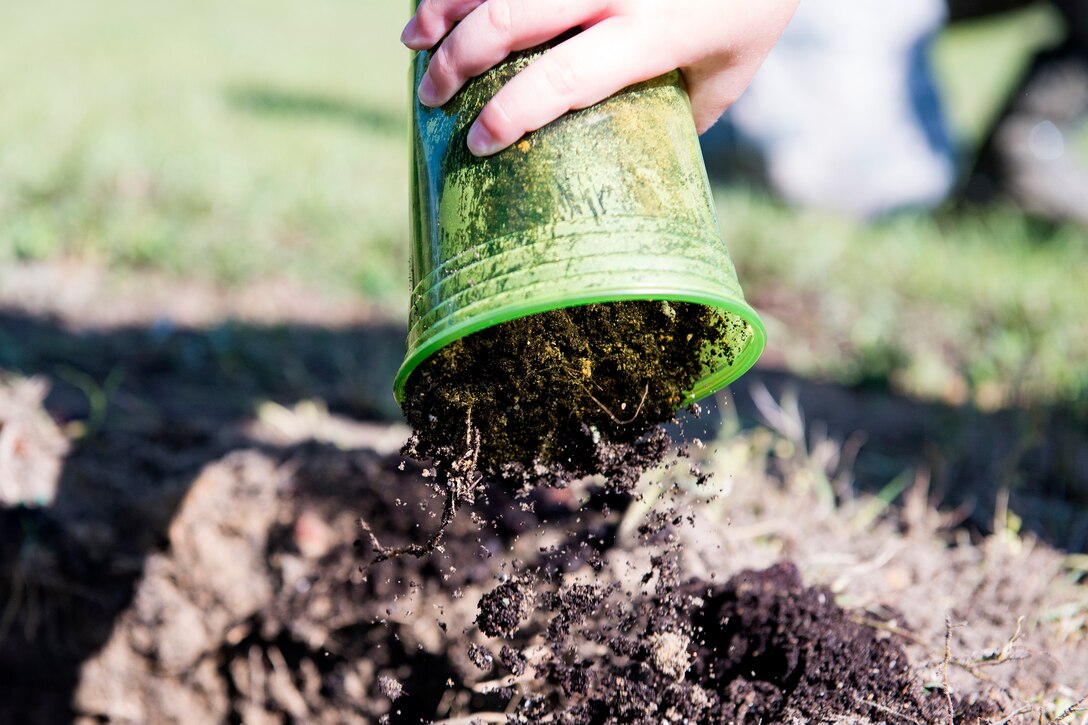 A child from Moody’s child development center prepares to plant an oak tree during Arbor Day, April 27, 2018, at Moody Air Force Base, Ga. Moody annually celebrates the holiday which encourages the benefits of planting trees. For 19 years the base has been a part of the Tree City USA Program by the National Arbor Day Foundation, to better prepare for the future of caring for their Airmen through improved ecological sustainability. (U.S. Air Force photo by Airman 1st Class Erick Requadt)