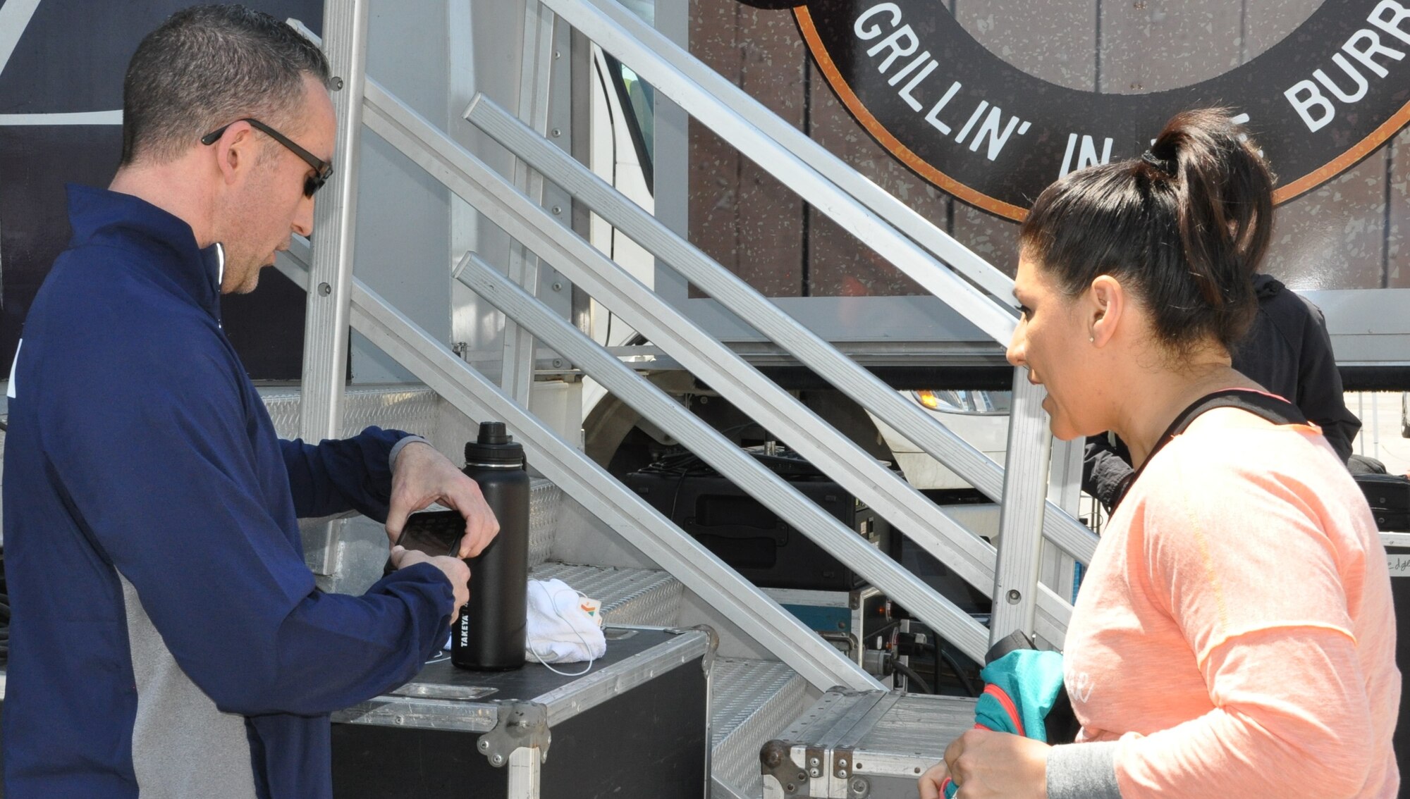 Lt. Col. Thomas Lessner goes over the plan with a Schertz “Movin’ on Main” co-instructor during the early April community health event. Lessner was a guest instructor, teaching  body flow (a hybrid of tai chi, pilates and yoga) during the event, and will teach again during this weekend’s San Antonio YMCA Siclovia event. (U.S. Air Force photo by Debbie Gildea)