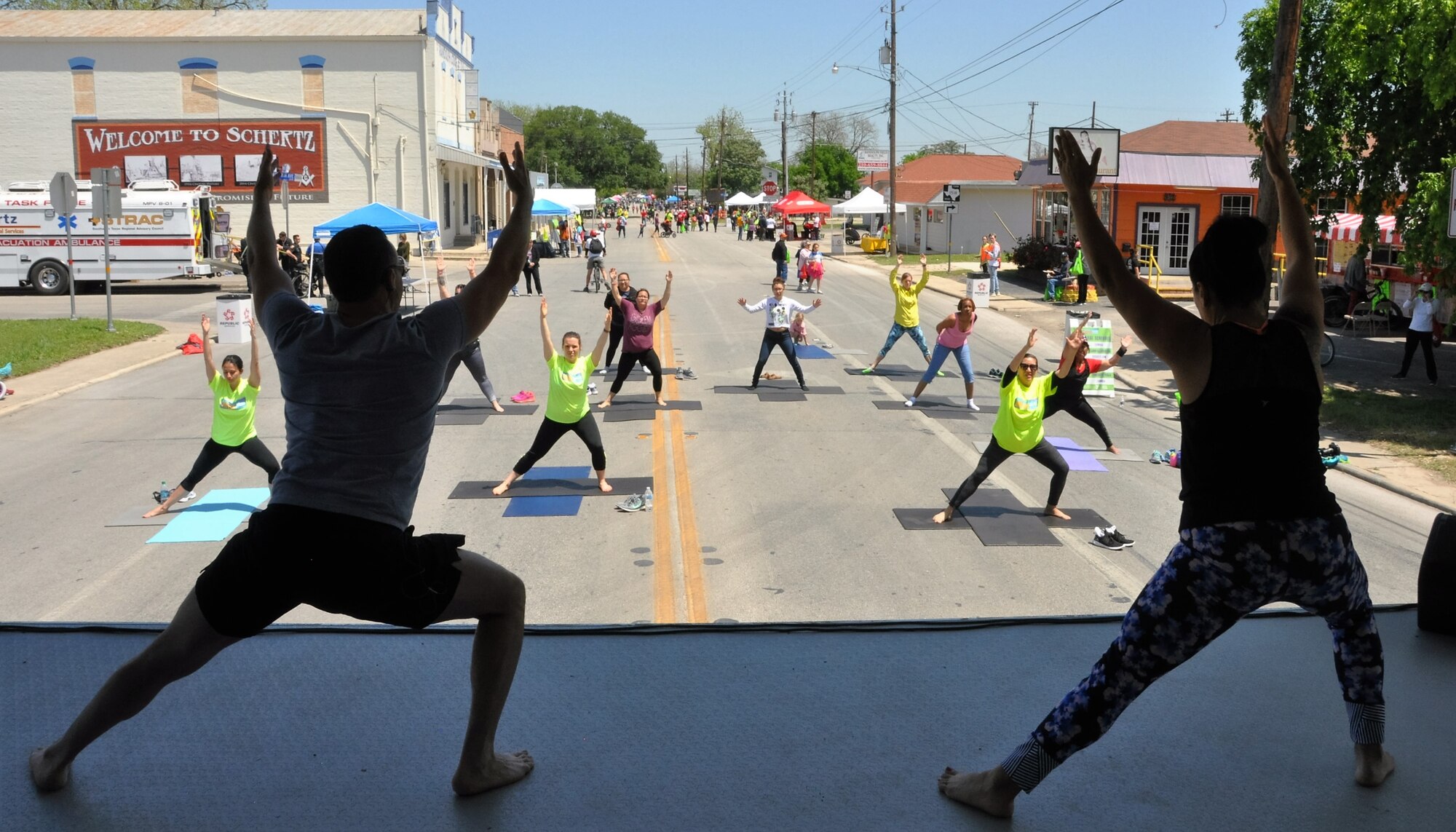 Lt. Col. Thomas Lessner and a co-instructor teach body flow (a hybrid of tai chi, pilates and yoga) during the recent City of Schertz “Movin’ on Main” community health event. (U.S. Air Force photo by Debbie Gildea)