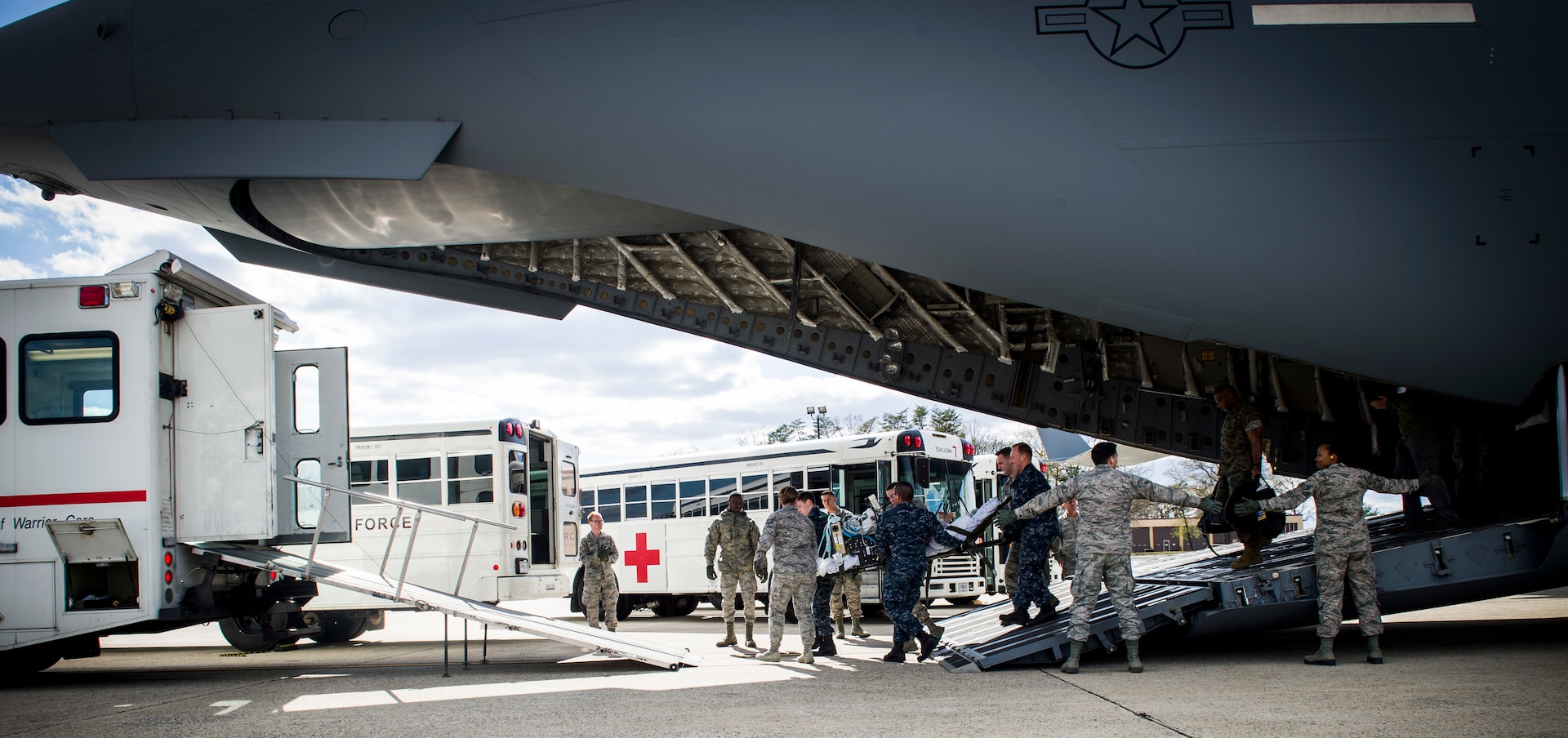 59th Medical Wing CCATT team members, in conjunction with mission partners, transition from their aircraft to an ambulance during an infant patient transport mission from Germany to Walter Reed National Medical Center, Bethesda, Md., April 19th, 2018. Examples of conditions requiring CCATT support include supportive or resuscitate care of shock/hemorrhage, respiratory failure, and multi-system trauma.