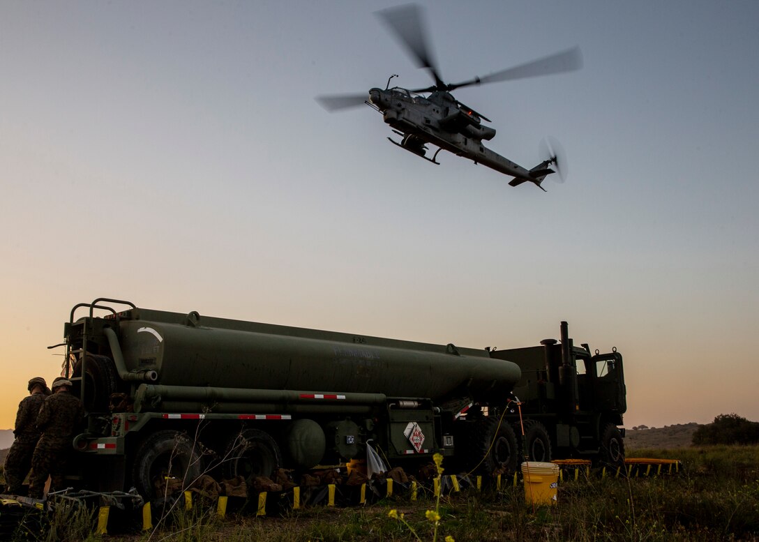 An AH-1Z Viper with Marine Light Attack Helicopter Squadron (HMLA) 469, Marine Aircraft Group 39, 3rd Marine Aircraft Wing, lands near a M31/970 resupply truck during forward arming and refueling point operations at Marine Corps Base Camp Pendleton, Calif., April 26. Marine Wing Support Squadron 372, MAG-39, 3rd MAW and HMLA-469 conducted a day and night FARP for training in aerial operations support. (U.S. Marine Corps photo by Lance Cpl. Clare J. McIntire/Released)