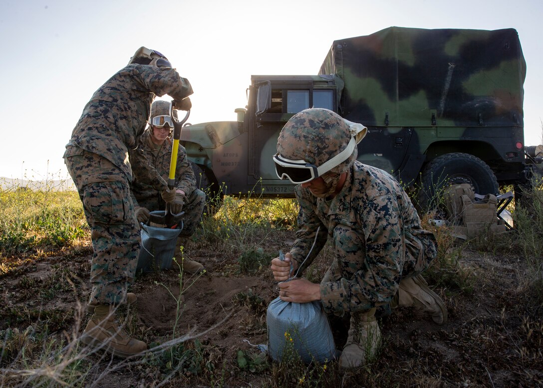 Marines with Marine Wing Support Squadron (MWSS) 372, Marine Aircraft Group 39, 3rd Marine Aircraft Wing, fill sand bags at Marine Corps Base Camp Pendleton, Calif., April 26. MWSS-372 and Marine Light Attack Helicopter Squadron (HMLA) 469, MAG-39, 3rd MAW conducted a day and night forward arming and refueling point for training in aerial operations support. (U.S. Marine Corps photo by Lance Cpl. Clare J. McIntire/Released)