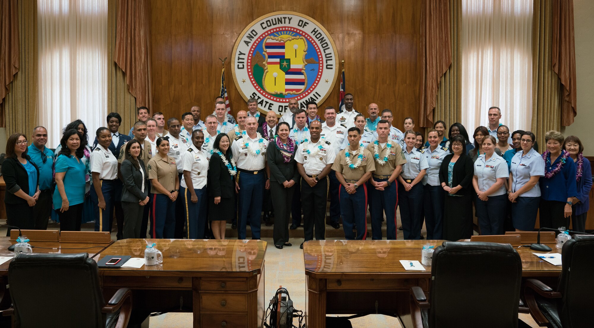 Members of the Honolulu City Council, local service members and community action team members pose for a group photo during the Sexual Assault Awareness Month Proclamation Ceremony at Honolulu City Hall April 18, 2018.