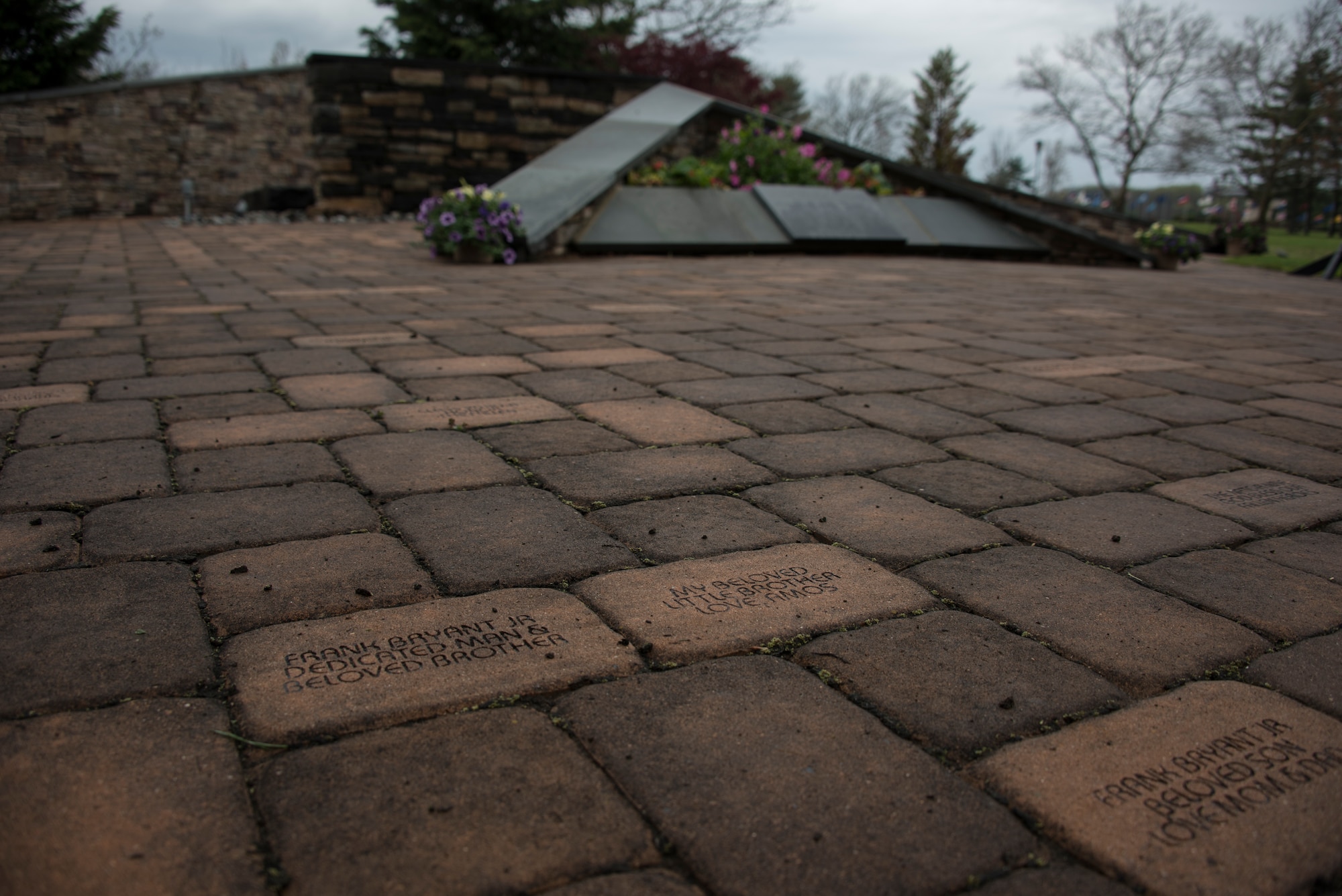 The Air Advisor Memorial stands behind the Air Advisor Academy building April 27, 2018 on Joint Base McGuire-Dix-Lakehurst, N.J. The memorial stands on red bricks that hold engravings donated by family members and loved ones in honor of the nine NATO Air Trade and Command/Afghanistan Airmen that were killed during a tour in the Middle East in 2011. (U.S. Air Force photo by Airman Ariel Owings)
