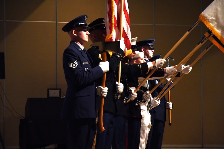 The Goodfellow Air Force Base Joint Color Guard, begin the ceremony for the 16th Annual Firefighter Ball, with a presentation of the colors at the McNease Convention Center, San Angelo, Texas, April 28, 2018. Department of Defense firefighters, friends and family were able to enjoy a meal and socialize during the event. (U.S. Air Force photo by Airman 1st Class Seraiah Hines/Released)