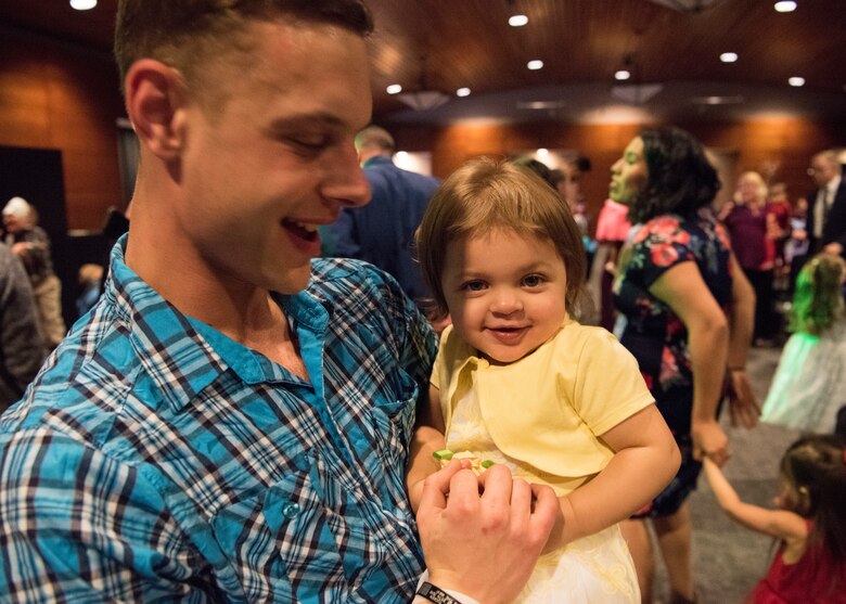 Army Staff Sgt. Dillon Bonine, from the 3rd Battalion, 509th Infantry Regiment, dances with daughter Aurora, age 1, during the Father/Daughter and Mother/Son Dance at Joint Base Elmendorf-Richardson’s Arctic Warrior Events Center, April 27, 2018. The event was sponsored by the Family Advocacy Program, the Sexual Assault Prevention and Response Office, the 673d Medical Group, and the USO. Attendees had the chance to partake in Information booths, a build-your-own ice cream sundae bar and dancing.