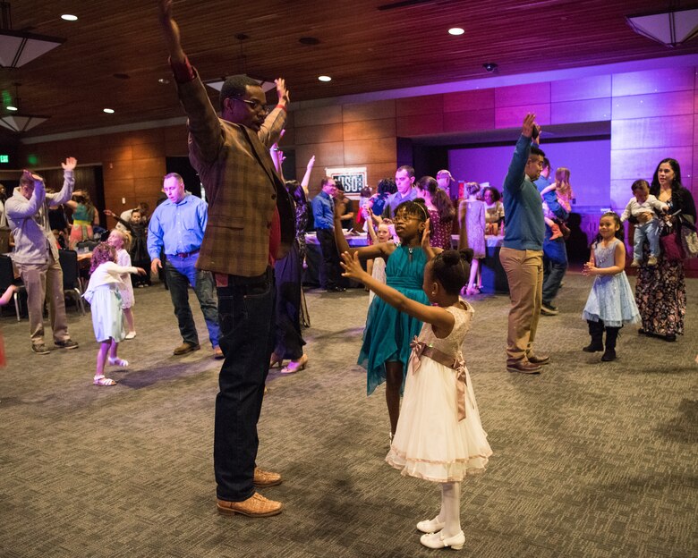 Eric Shorter dances with his daughters Emory, age 10 and Espe, age 6, during the Father/Daughter and Mother/Son Dance at Joint Base Elmendorf-Richardson’s Arctic Warrior Events Center, April 27, 2018. The event was sponsored by the Family Advocacy Program, the Sexual Assault Prevention and Response Office, the 673d Medical Group, and the USO. Attendees had the chance to partake in Information booths, a build-your-own ice cream sundae bar and dancing.
