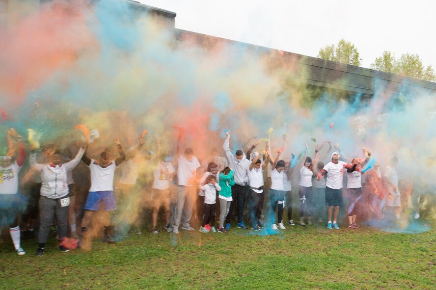 Participants of the Sexual Assault Awareness Month Color Run kick off the event by throwing colored powder into the air April 25, 2018, at Dover Air Force Base, Del. The run, aimed at raising awareness of sexual assault and to reinforce the motto, “protecting our people protects our mission,” was one of several events hosted by the Dover AFB SAPR office during Sexual Assault Awareness Month. (U.S. Air Force photo by Mauricio Campino)