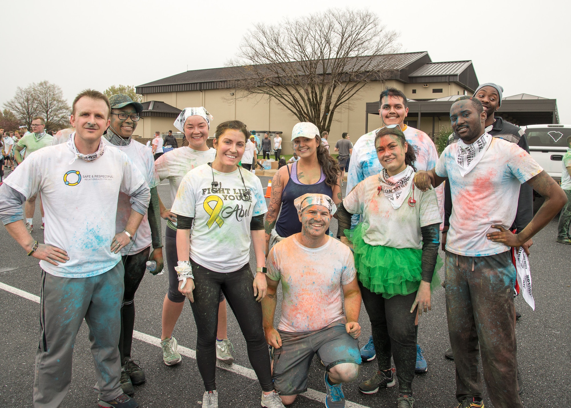 Participants pose for a photo at the finish line of the Sexual Assault Awareness Month Color Run April 25, 2018, at Dover Air Force Base, Del. Some runners chose to run as a team while others ran individually. (U.S. Air Force photo by Mauricio Campino)