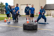 Amazing Race team members from the 3rd Airlift Squadron engage in two of the five designated challenges during Wingman Day April 27, 2018, at the fire department on Dover Air Force Base, Del. Each Amazing Race team included at least one Airman, NCO, senior NCO and an officer. Civilians and spouses were also encouraged to join their unit’s team. (U.S. Air Force photo by Roland Balik)