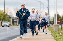 Staff Sgt. Jose Marroquin, 436th Maintenance Group maintenance analyst, leads his Wingman Day Amazing Race team as they run to their next challenge location April 27, 2018, on Dover Air Force Base, Del. Upon completing each challenge, teams were given a clue instructing them to proceed to one of 10 designated Amazing Race locations. (U.S. Air Force photo by Roland Balik)