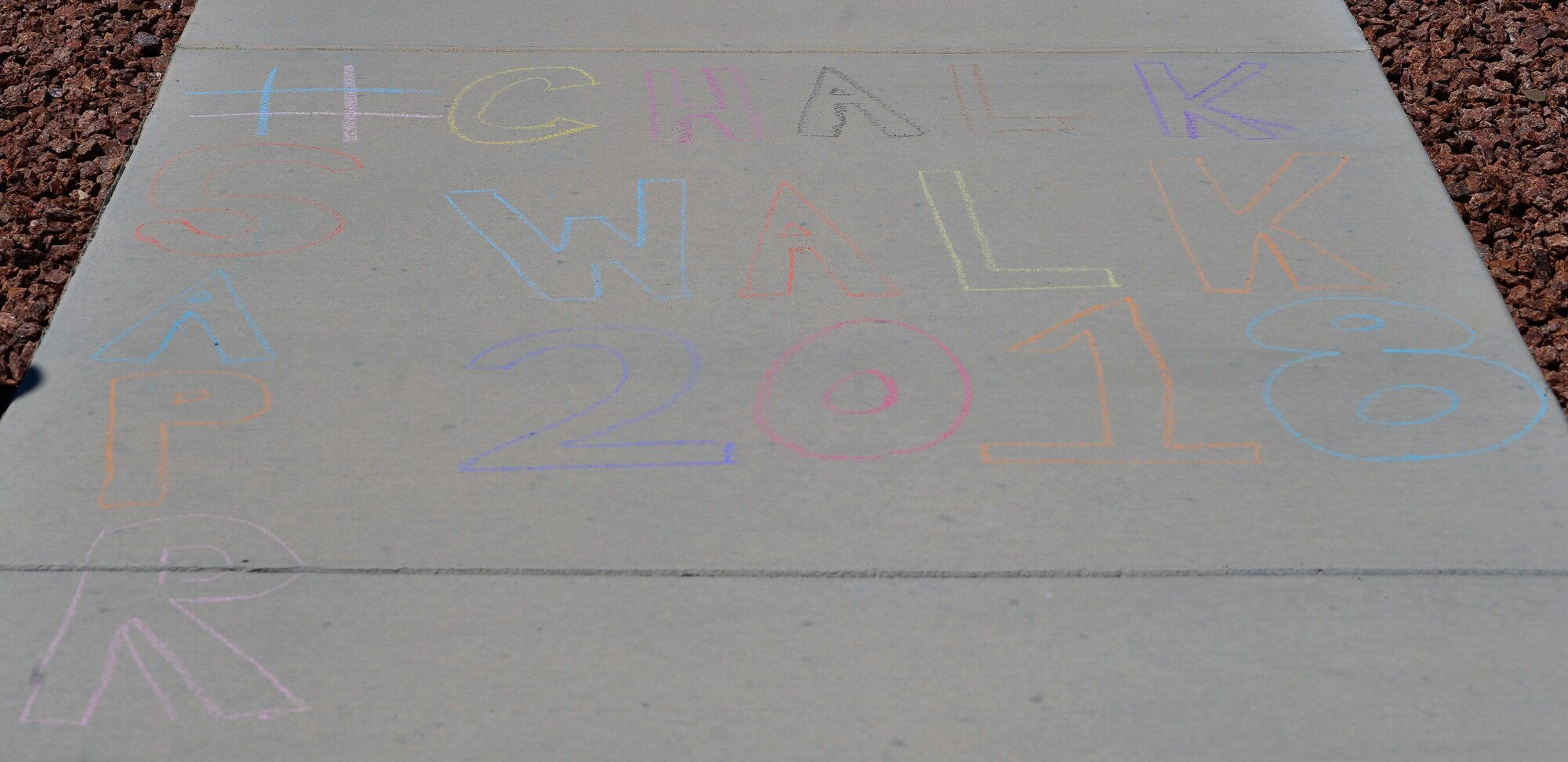 Airmen hosted a Chalk the Walk event to raise awareness and prevention of Sexual Assault for Sexual Assault Awareness and Prevention Month April 20, 2018, at Creech AFB, Nev. Many Airmen grabbed a piece of brightly colored chalk and marked words of support for their fellow Airmen or family members who have been a victim of sexual assault. (U.S. Air Force photo by Airman 1st Class Haley Stevens)