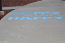 Creech Airmen had the opportunity to write supportive words or phrases on the sidewalks leading to the base dining facility during a Chalk the Walk event April 20, 2018, at Creech Air Force Base, Nev. This event was in support of Sexual Assault Awareness and Prevention Month, which is a month-long observance that allows the DoD to continue supporting victims while improving outreach and sexual assault prevention. (U.S. Air Force photo by Airman 1st Class Haley Stevens)