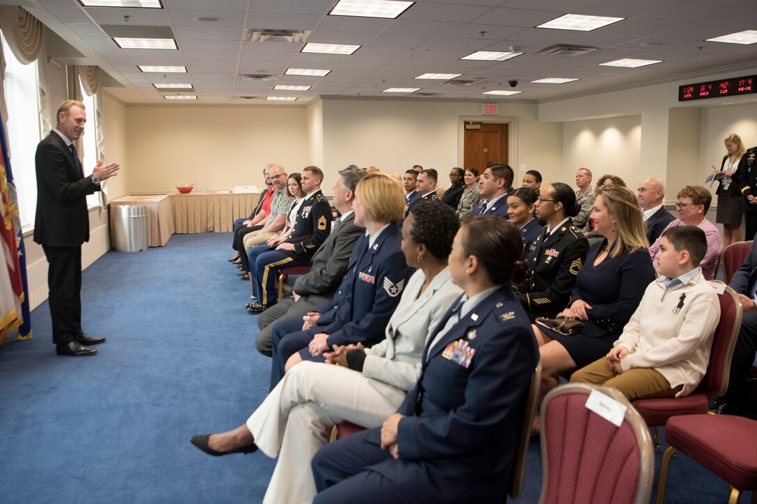 The deputy secretary of defense speaks to a group of people.