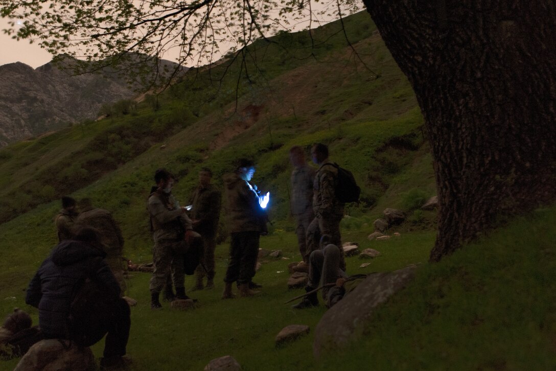 Tajik and U.S. Soldiers form a plan late in the evening at a mountain training camp outside of Dushanbe, Tajikistan, April 24, 2018, during an exercise to exchange tactics between Tajik and U.S. forces. This information exchange was part of a larger military-to-military engagement taking place with the Tajikistan Peacekeeping Battalion of the Mobile Forces and the 648th Military Engagement Team, Georgia Army National Guard, involving border security tactics and techniques.