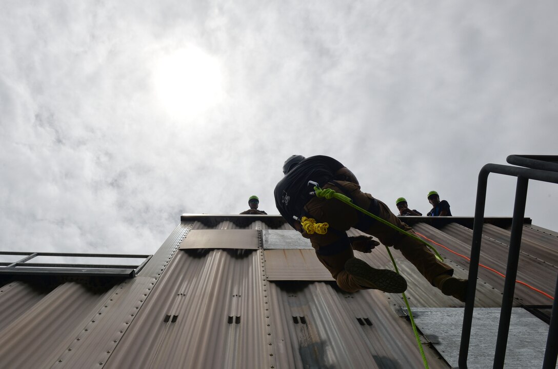 Tech. Sgt. Justin Andreas, 554th REDHORSE Squadron Fire Emergency Services Contingency Training instructor, demonstrates rapelling to students from the Republic of Korea Air Force April 22, 2018, at Andersen Air Force Base, Guam. The training took part during the routine Silver Flag, testing the U.S. and its partner nations on their capabilities to perform emergency services in all types of scenarios. (U.S. Air Force photo by Tech. Sgt. Jake M. Barreiro)