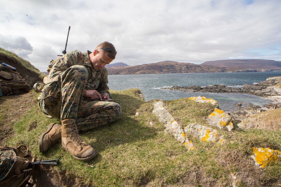 Maj. Graham Perry, the officer in charge of 4th Air Naval Gunfire Liaison Company, Force Headquarters Group, checks his Android Tactical Assault Kit to see possible target areas, in Cape Wrath, Scotland, April 23, 2018. 4th ANGLICO is in Scotland to take part in Joint Warrior 18-1, an exercise that furthers their readiness and effectiveness in combined arms integration, small unit tactics and land navigation. This training aims at improving their capabilities and combat effectiveness and ensures they're ready to fight tonight.