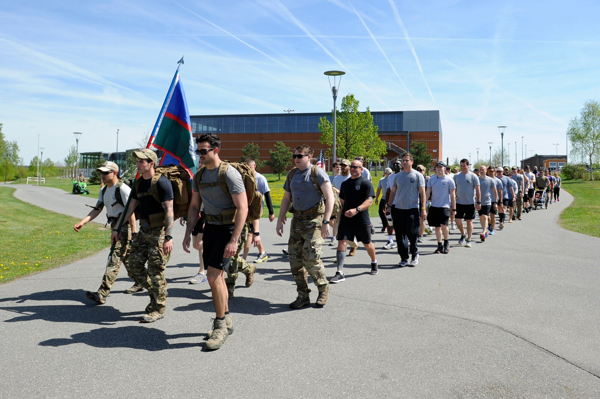 Tactical Air Control Party Airmen and their families from across Europe march the final mile as a group during the 7th Annual TACP 24-hour Run Challenge at U.S. Army Garrison Bavaria, Germany, April 27, 2018. The 24-hour Run Challenge is a worldwide event consisting of TACP teams participating globally at the same time. Of the 75 participants, more than 1,050 miles were walked during the memorial run at USAG Bavaria. (U.S. Air Force photo by Senior Airman Savannah L. Waters)